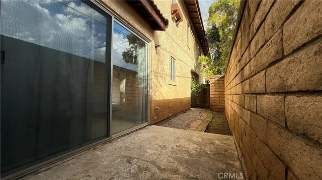 a view of barbeque area with brick wall