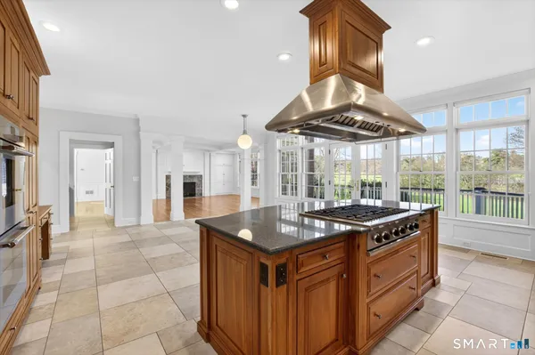 a view of empty room with wooden floor and fireplace
