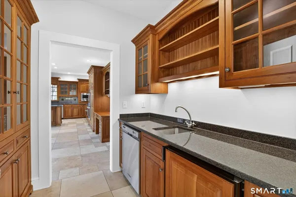 a view of an empty room with wooden floor fireplace and a window