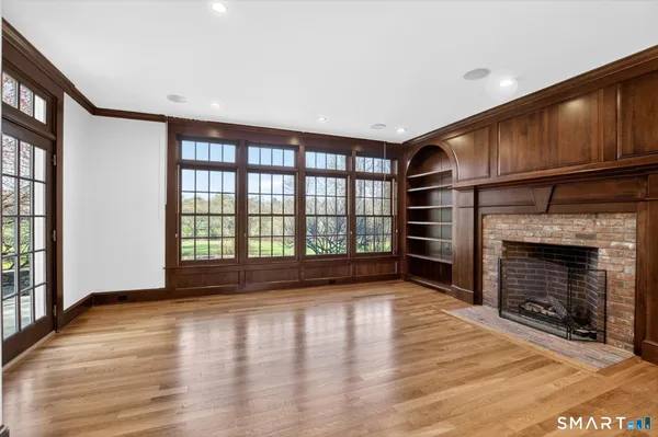 a view of empty room with wooden floor