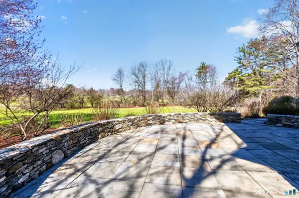 a view of kitchen with stainless steel appliances granite countertop a refrigerator and a stove top oven