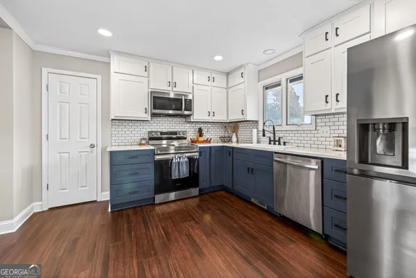 a kitchen with stainless steel appliances a microwave a stove a sink dishwasher and a refrigerator