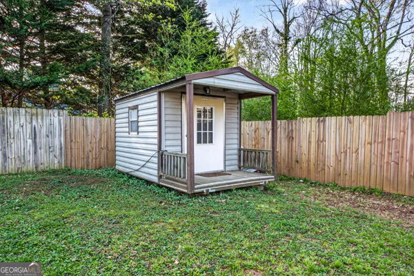 a view of a small yard with wooden fence