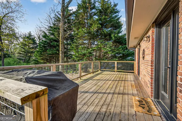 a view of roof deck with wooden floor and fence