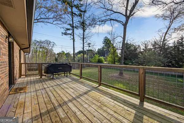 a view of balcony with wooden floor and bench