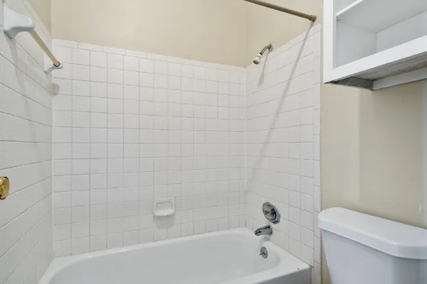 a bathroom with a bathtub and a toilet