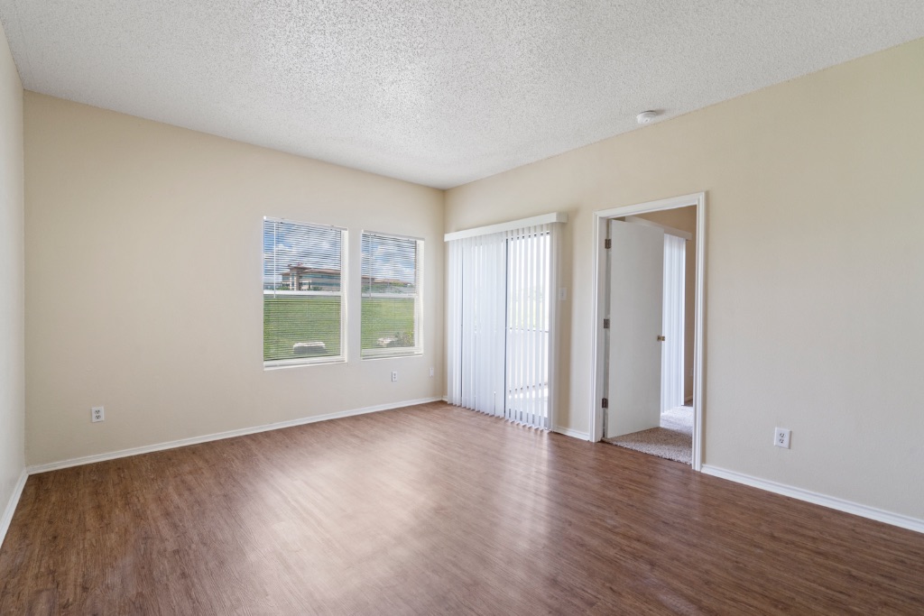 12166 Metric Boulevard, Unit 1013 Austin, TX 78758 - Photo 4 of 16 Spare room featuring dark wood finished floors and a textured ceiling
