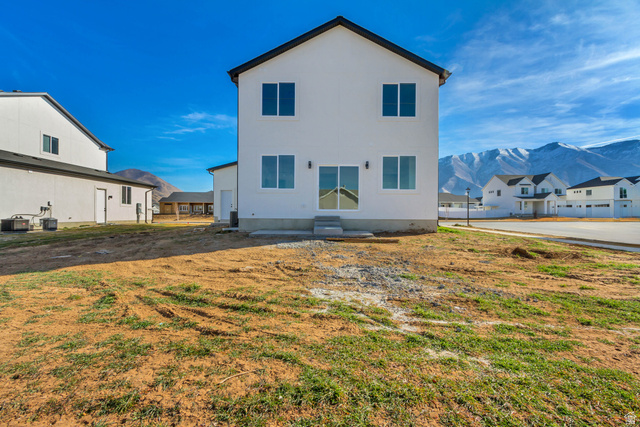 547 North Hvn Drive Mapleton, UT 84664 - Photo 22 of 23 Rear view of house featuring a mountain view, a lawn, and a residential view