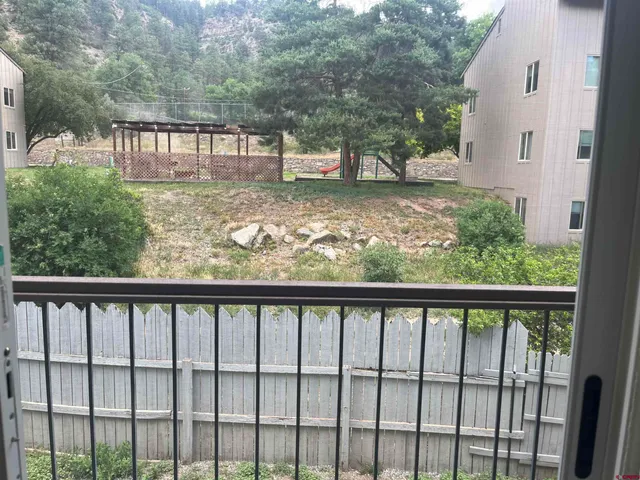 a view of a wooden fence and a yard