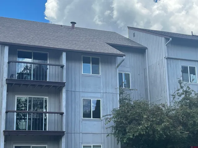 a front view of a house with plants