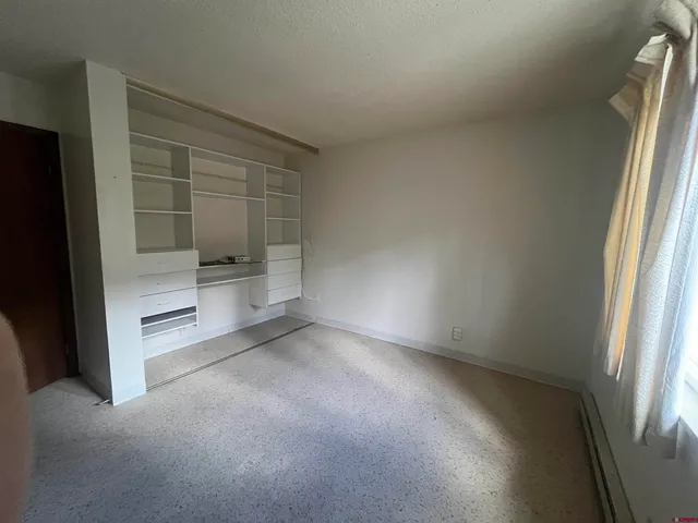 an empty room with a empty space and windows