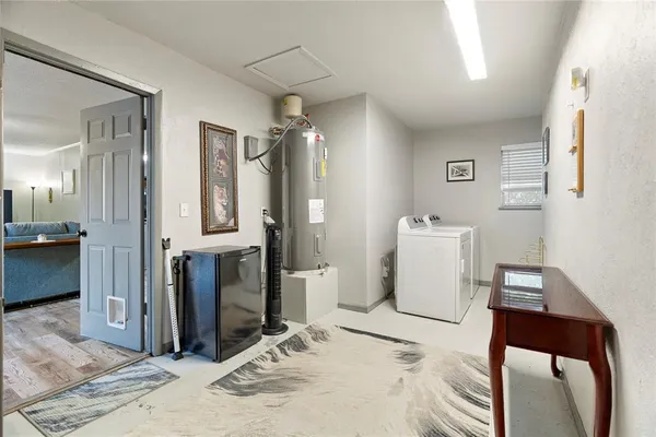a view of a hallway with dining area and chandelier