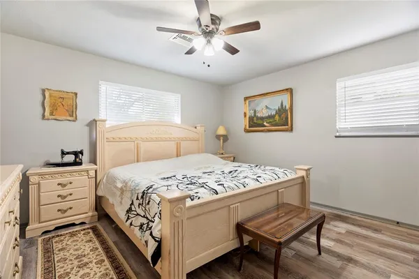 a bedroom with a bed and a dresser in it