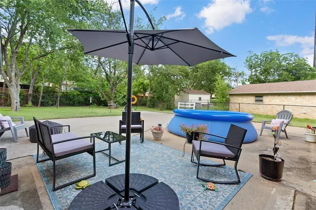 a view of a chairs and table in the patio