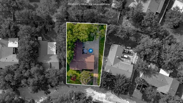 an aerial view of a house with a yard