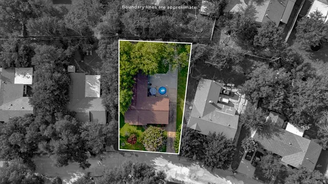 an aerial view of a house with a yard