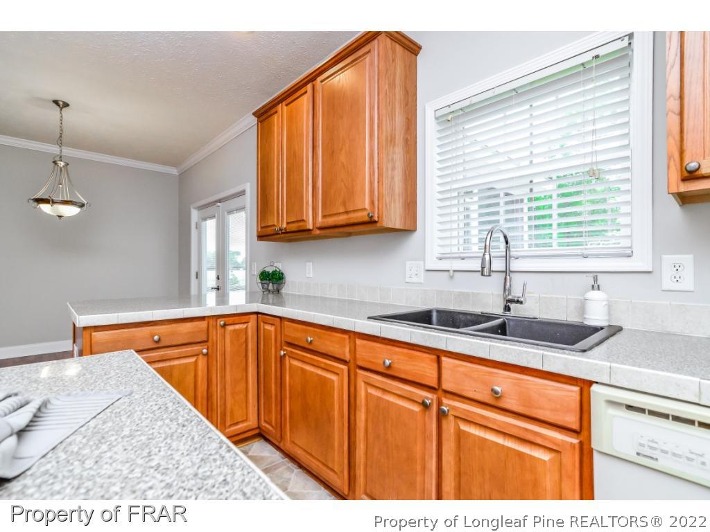 7347 Maxwell Road Stedman, NC 28391 - Photo 11 of 28 a kitchen with granite countertop cabinets sink and window