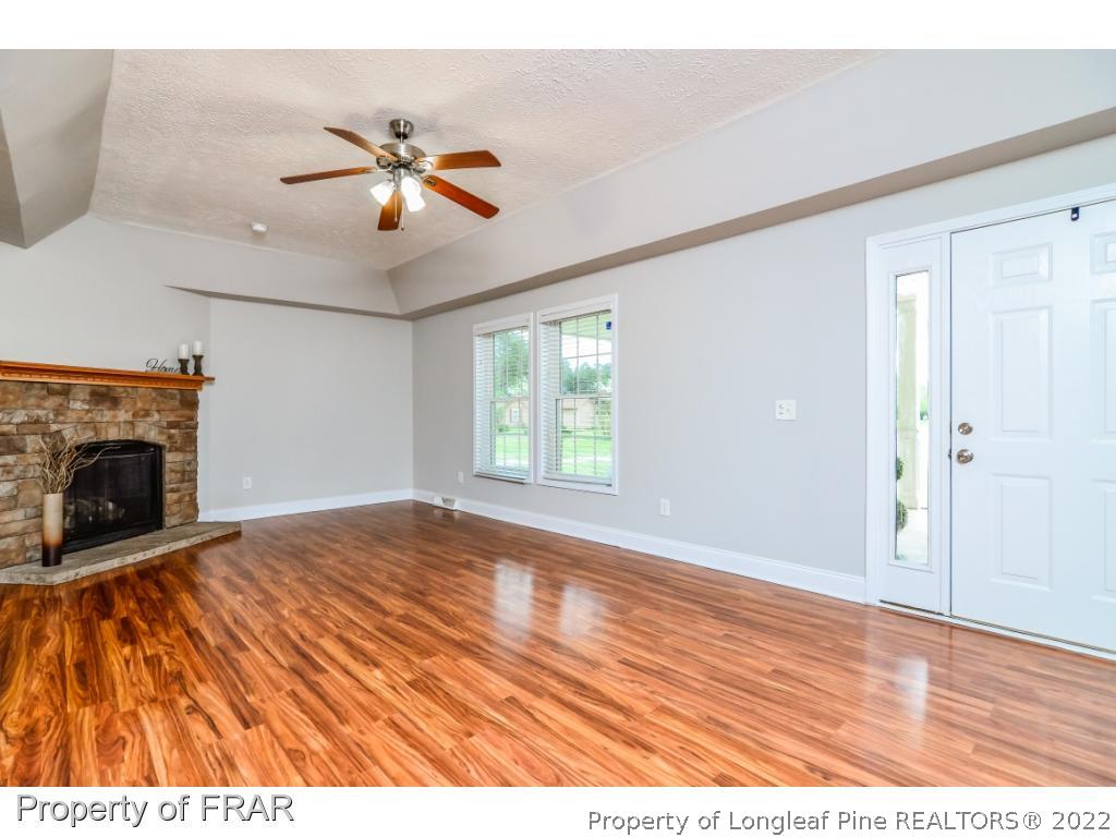 7347 Maxwell Road Stedman, NC 28391 - Photo 2 of 28 a view of empty room with wooden floor and fan