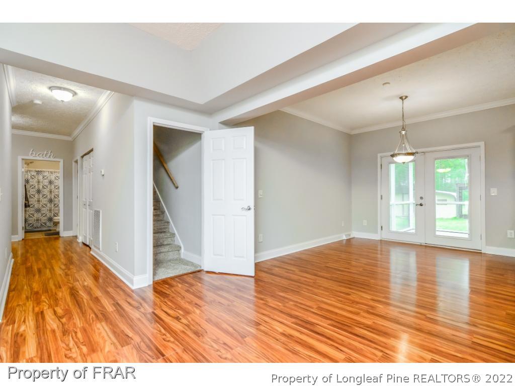 7347 Maxwell Road Stedman, NC 28391 - Photo 4 of 28 a view interior of a house wooden floor an entryway and a chandelier