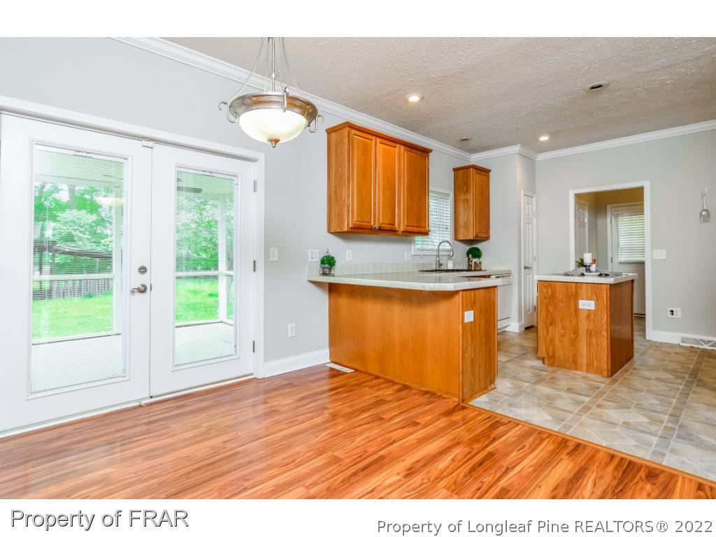7347 Maxwell Road Stedman, NC 28391 - Photo 6 of 28 a kitchen with stainless steel appliances granite countertop a sink and a wooden cabinets