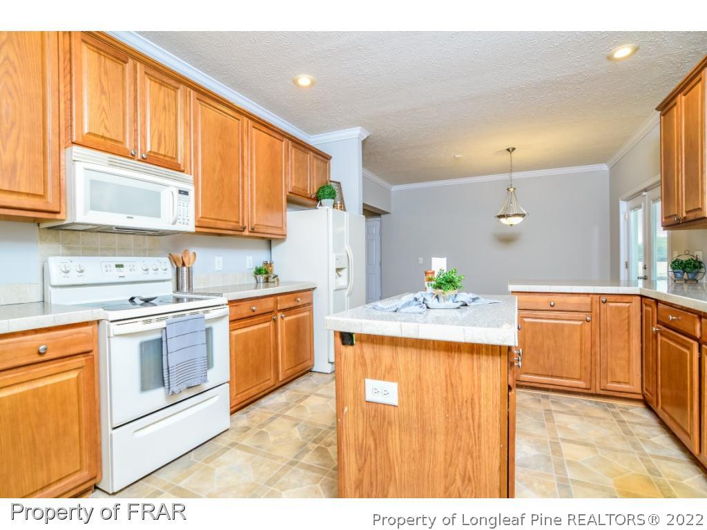 7347 Maxwell Road Stedman, NC 28391 - Photo 8 of 28 a kitchen with a sink stove and cabinets
