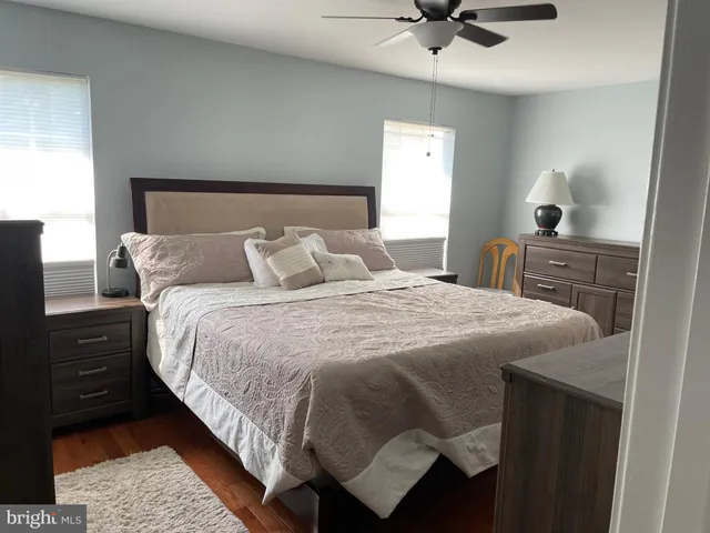 a bedroom with a bed and a ceiling fan