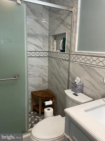 a bathroom with a toilet a sink and mirror