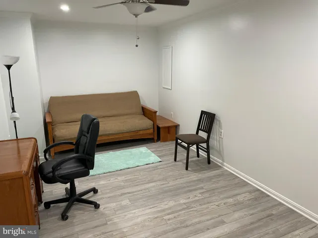 a view of a workspace room with wooden floor