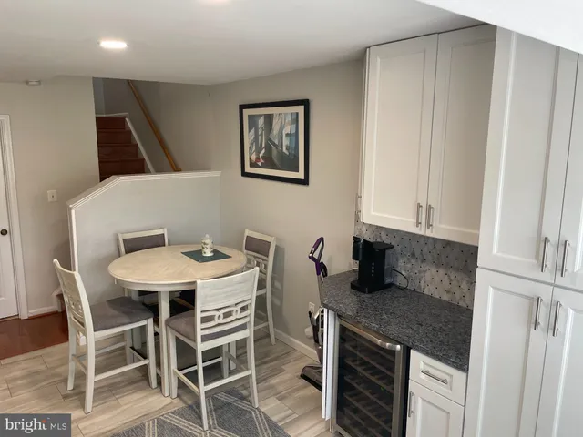 a kitchen that has a table and chairs in it