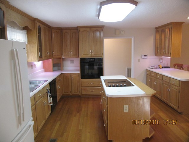 1748 Fred Hall Road Gordon, GA 31031 - Photo 14 of 28 a kitchen with a stove sink and a refrigerator