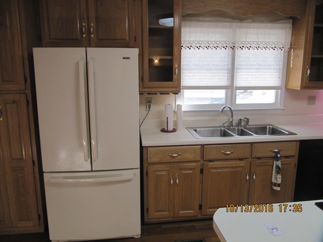 1748 Fred Hall Road Gordon, GA 31031 - Photo 15 of 28 a white refrigerator freezer sitting inside of a kitchen