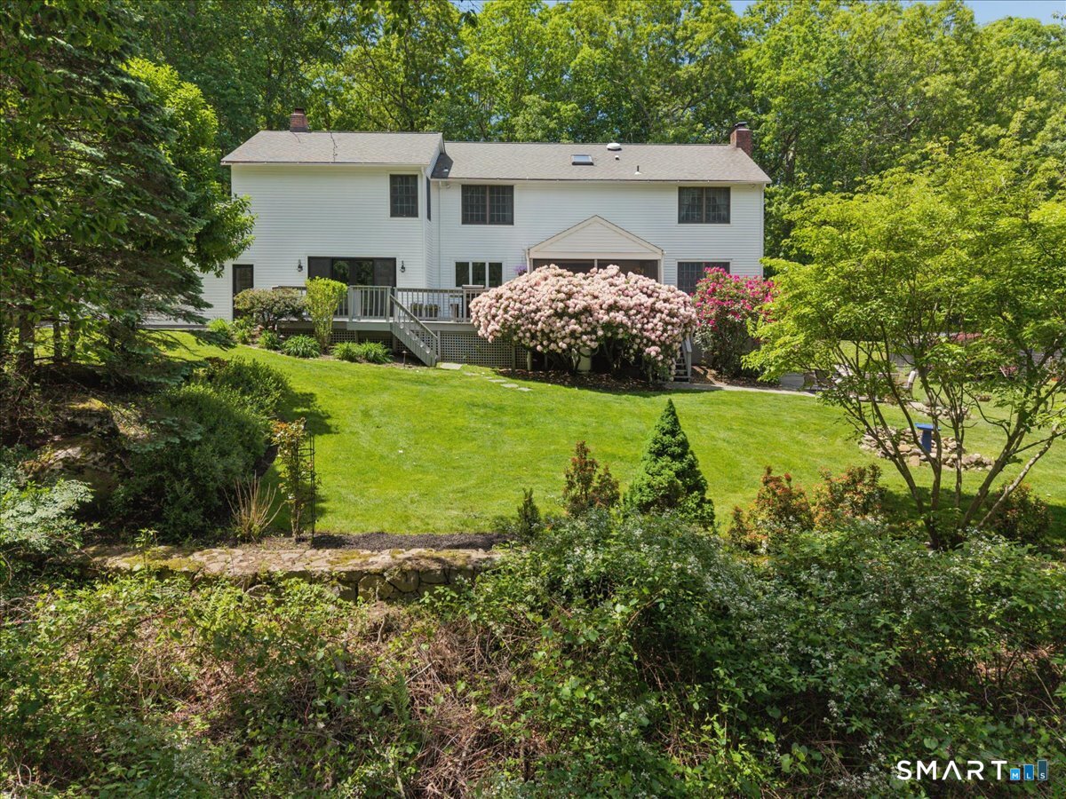 94 Vista Road Wilton, CT 06897 - Photo 35 of 38 a view of a backyard with plants and large tree