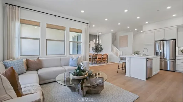 a living room with furniture and kitchen view