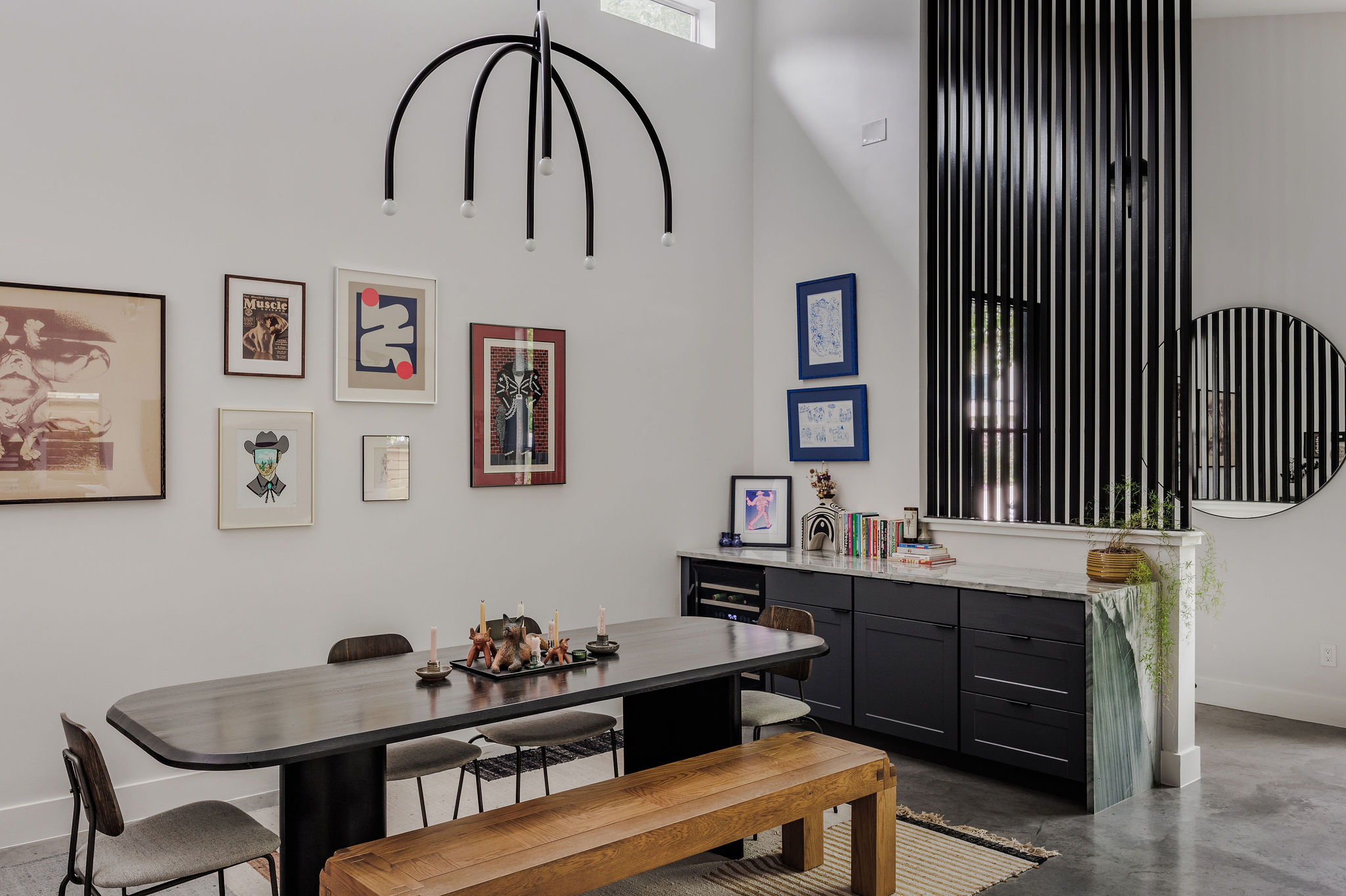 1605 Maple Avenue Austin, TX 78702 - Photo 8 of 33 Dining area featuring a modern black arc chandelier, high ceilings, and polished concrete flooring