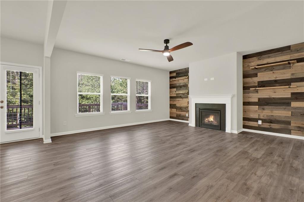 56 Preserve Point Jasper, GA 30143 - Photo 16 of 49 an empty room with wooden floor fireplace and windows