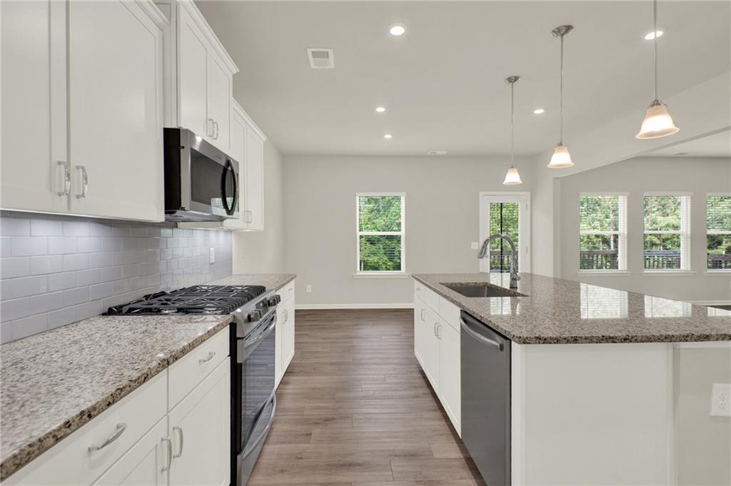 56 Preserve Point Jasper, GA 30143 - Photo 23 of 49 a kitchen with stainless steel appliances granite countertop a sink a stove and a microwave