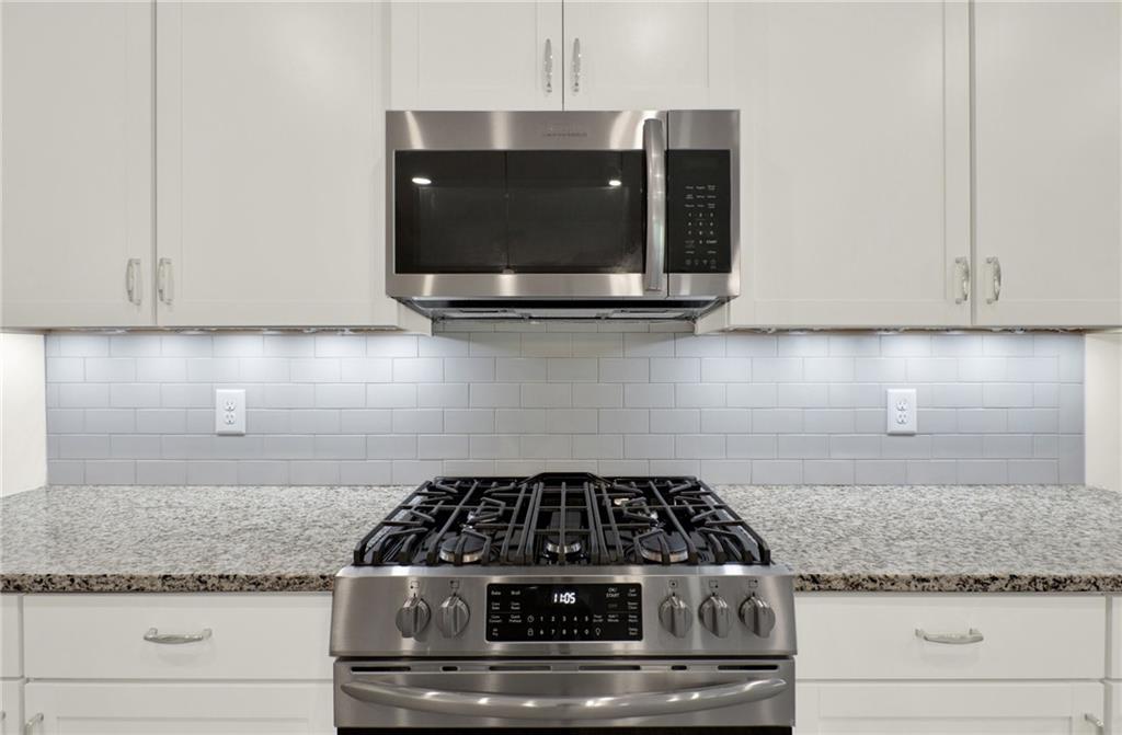 56 Preserve Point Jasper, GA 30143 - Photo 25 of 49 a kitchen with granite countertop white cabinets and stainless steel appliances