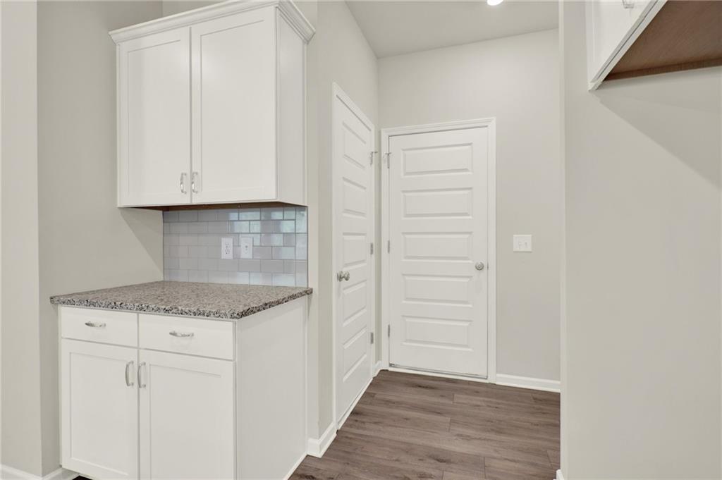 56 Preserve Point Jasper, GA 30143 - Photo 26 of 49 a kitchen with white cabinets and a wooden floor