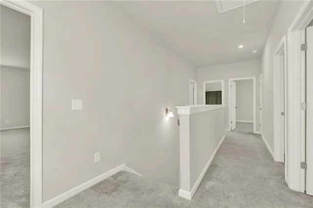 an empty room with windows and ceiling fan