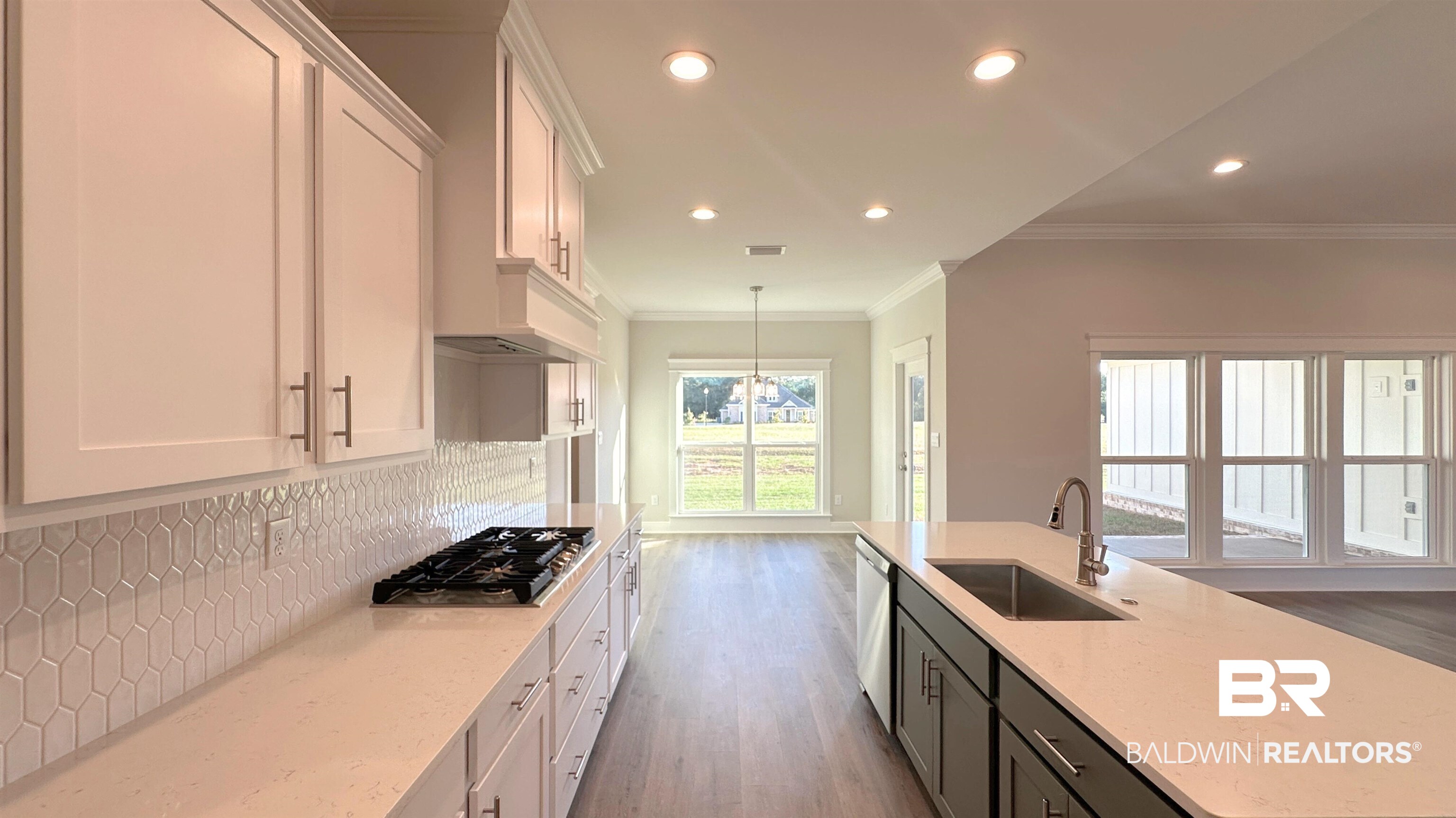126 Daybreak Trail Fairhope, AL 36532 - Photo 8 of 34 Kitchen featuring white cabinets, recessed lighting, light stone counters, ornamental molding, and tasteful backsplash