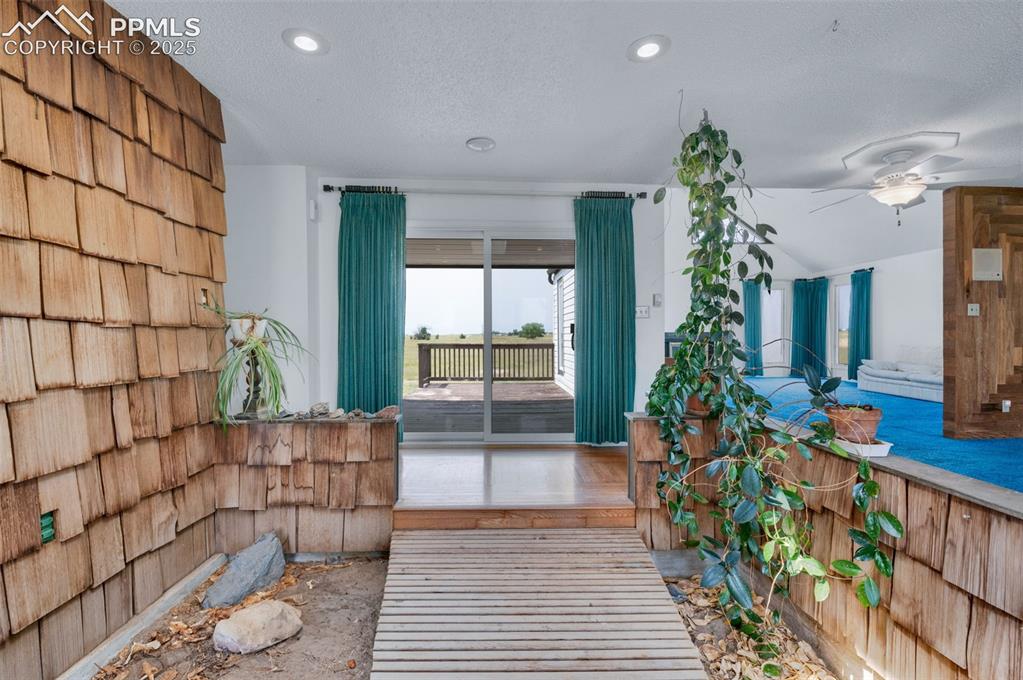 24975 Sanborn Road Calhan, CO 80808 - Photo 6 of 50 a living room filled with furniture and a potted plant