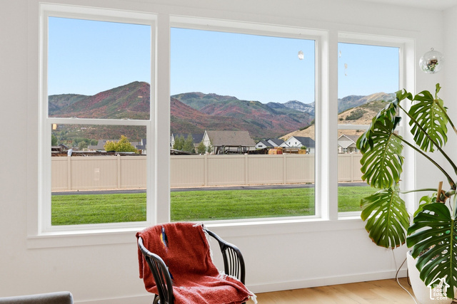 1295 North Canyon View Road Midway, UT 84049 - Photo 11 of 52 Expansive multi-pane window with mountain scenery, a manicured lawn, and wood-finish flooring