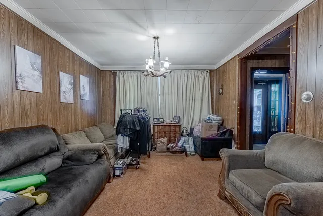 a living room with furniture and a chandelier