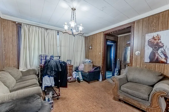 a living room with furniture and a chandelier