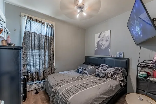 a bedroom with a bed and a chandelier