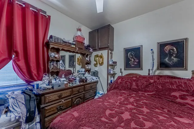 a bedroom with bed and cabinets