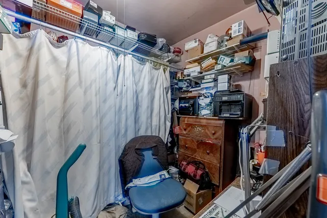 a view of walk in closet with clothes