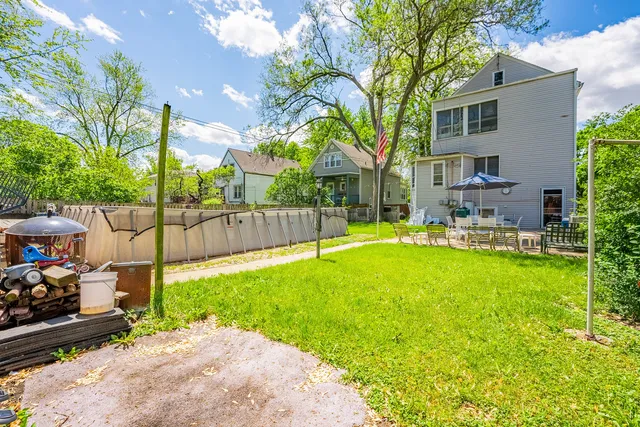 a backyard of a house with table and chairs