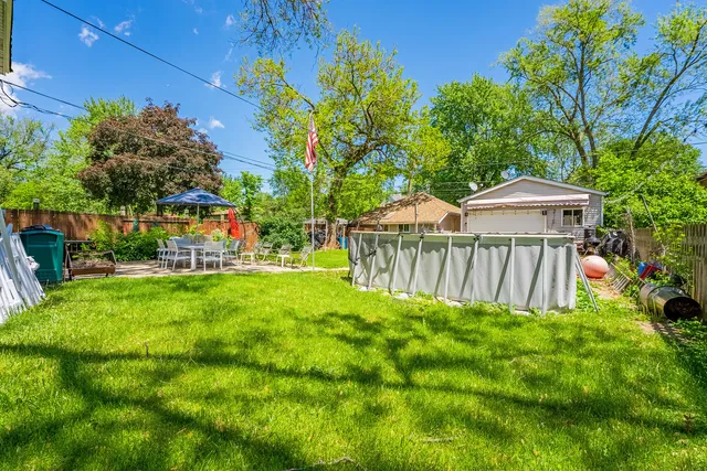 a view of backyard with a garden and deck
