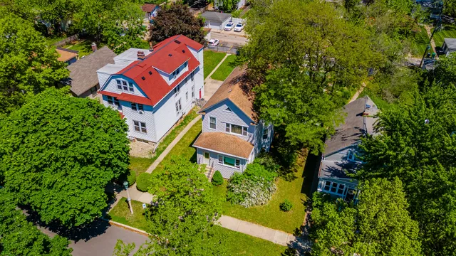 an aerial view of a house with swimming pool and garden space